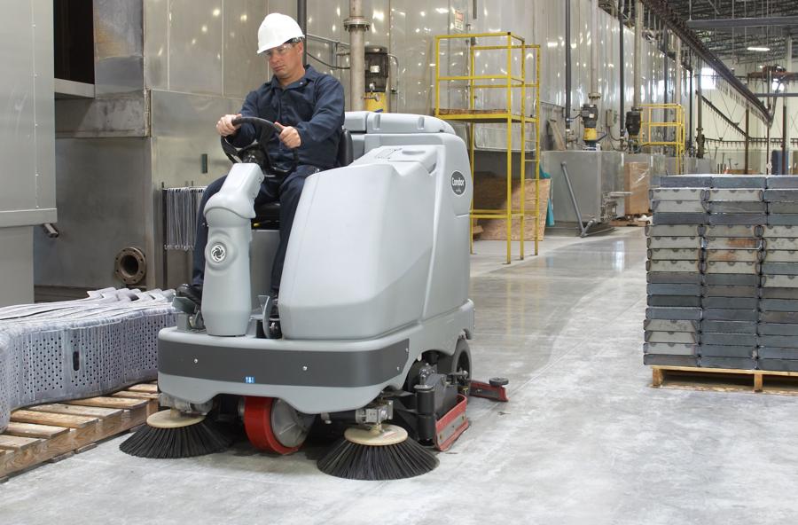 Industrial floor-cleaning equipment in use at a manufacturing plant